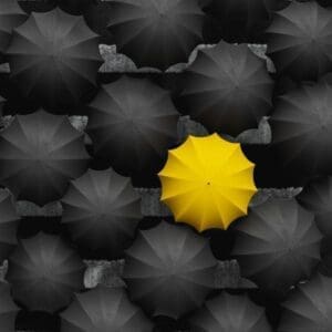 Recruitment vs.Talent Acquisition: Understanding the Differences. Umbrellas difference grey yellow stand out